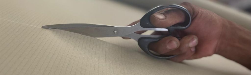 Ripstop being cut for custom length roll. 